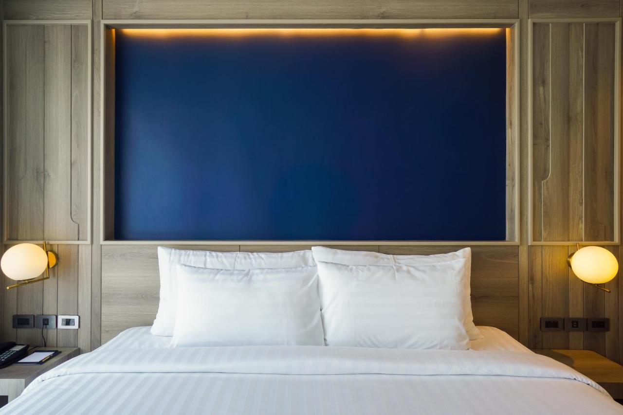 Seabed Grand Hotel Phuket - Sha Extra Plus Bagian luar foto A bed with two pillows